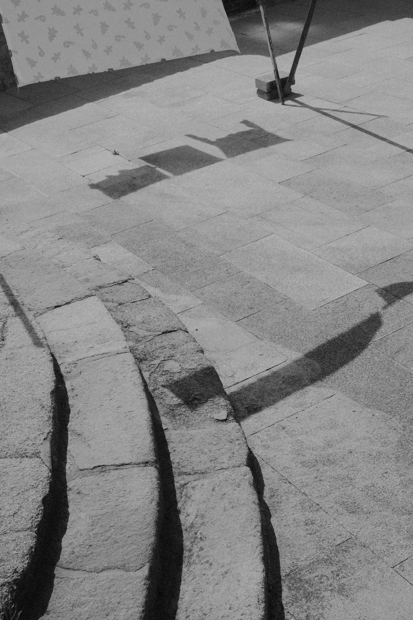 Black-and-white photograph of shadows on stone pavement from Seeking Grace.